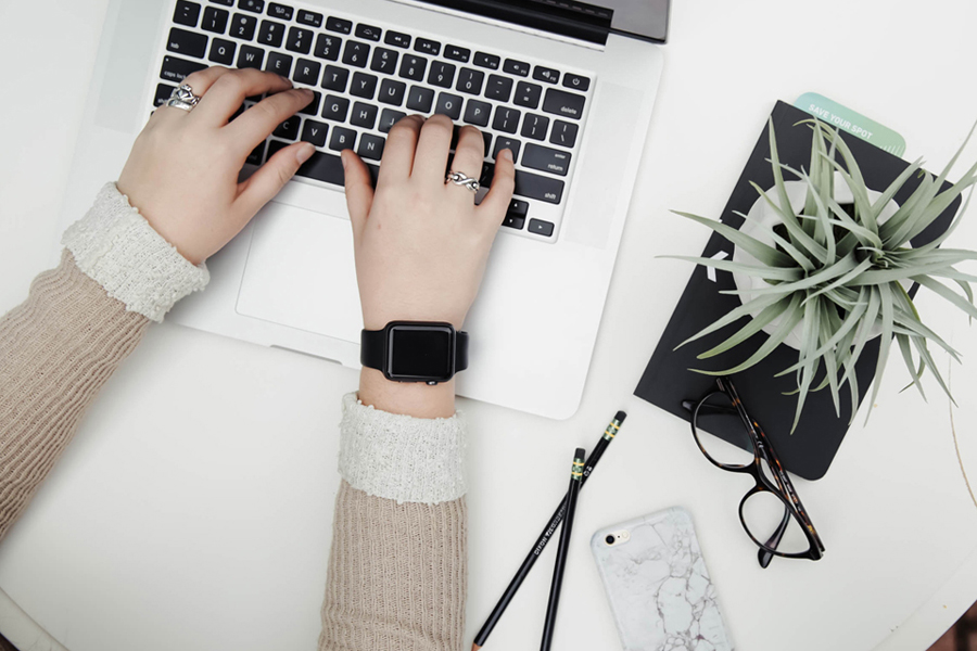 a woman's hands at a laptop