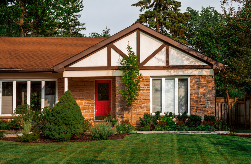 photo of an average looking mid-century bungalow nicely kept and mowed lawn